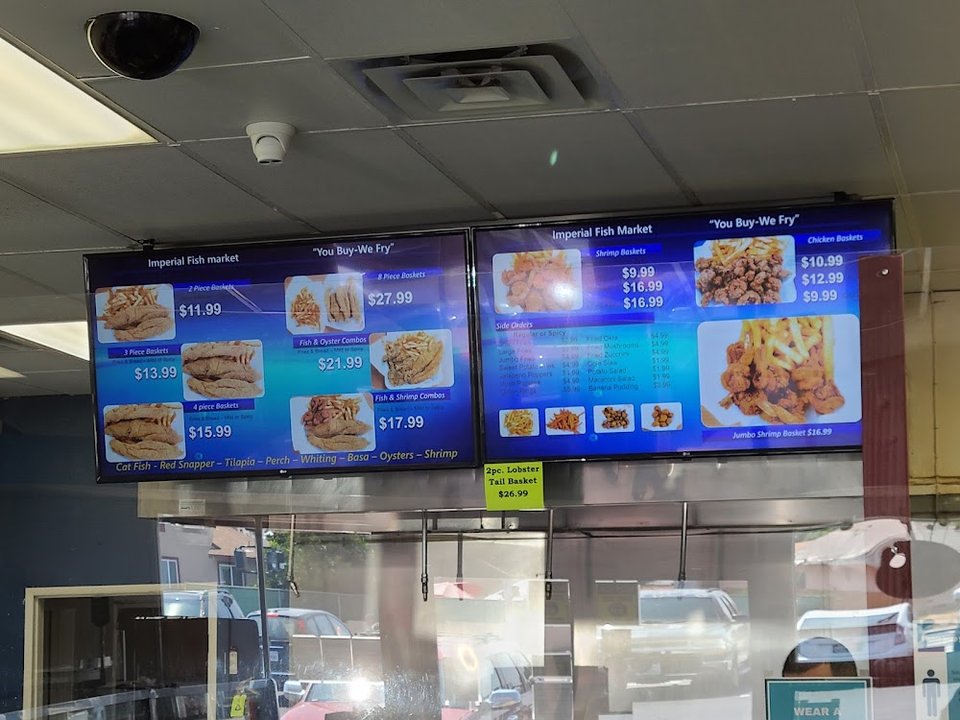 Printed menu with fried fish and sides.