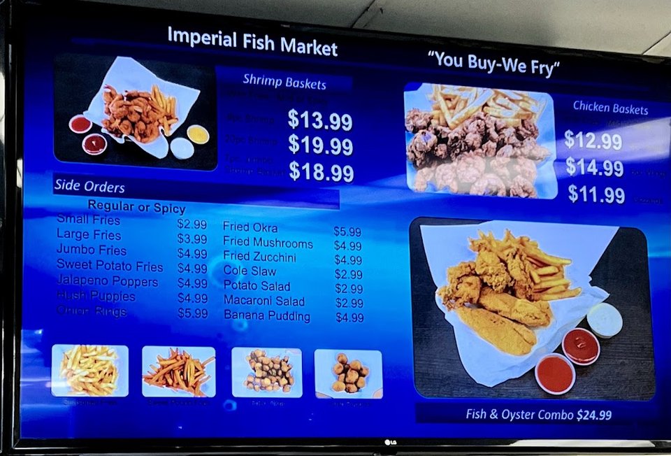 Seafood menu board beside the counter.